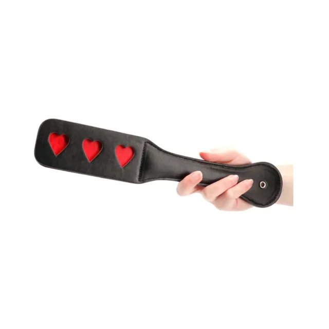 Black Ouch paddle with three red heart-shaped cutouts and rounded handle