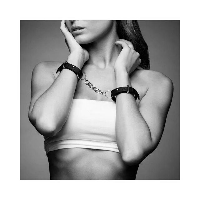 thin black Maze wrist cuffs joined by a silver chain and worn with buckles outward