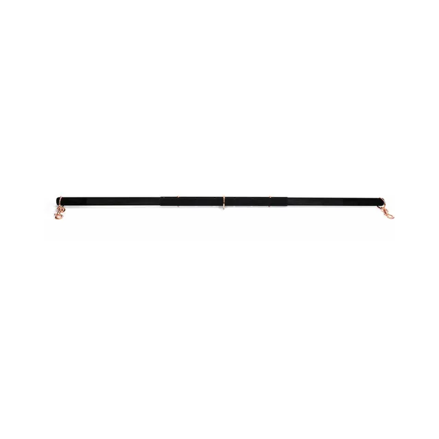 Fully extended black Coquette spreader bar on white background