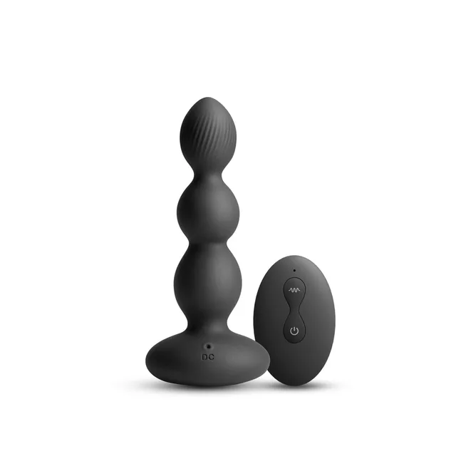 Black three-section Valor plug beside oval remote
