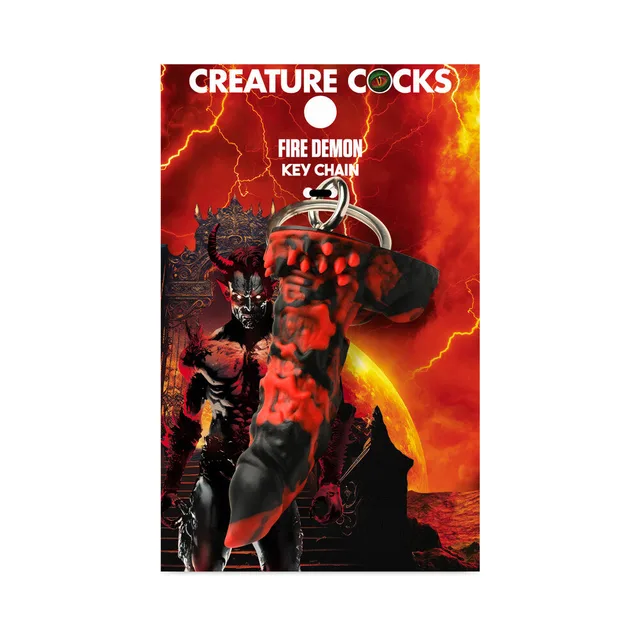red and black Creature Cocks Fire Demon silicone keychain on fiery card