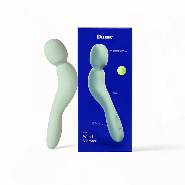 Dame Com sage curved wand vibrator beside its blue retail box