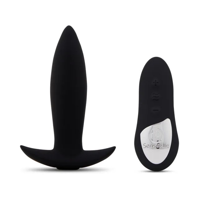 upright black silicone Mini Plug with flared base beside oval handheld remote