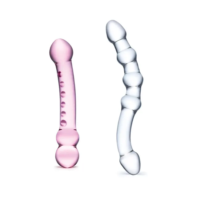 Pink straight and clear curved Glas dildos standing upright