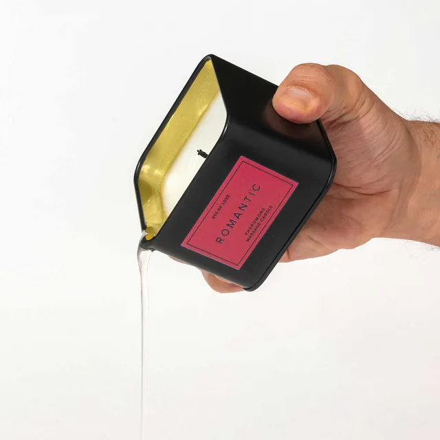 black Eye of Love Romantic candle with pink label and melted wax pouring