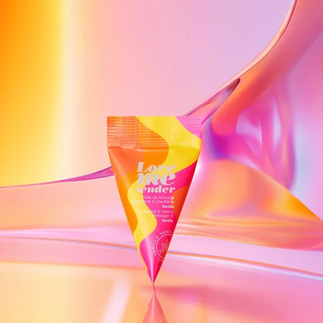 Love to Love Vanilla massage oil sachet angled packet among orange geometric shapes