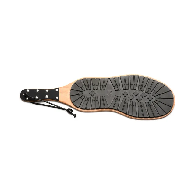 XR Brands Master Series Tread dual-sided boot paddle with black rubber sole texture and studded handle