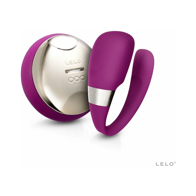 Purple TIANI 3 two-arm vibrator beside oval silver remote