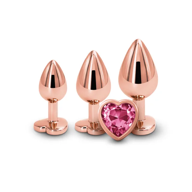 Three graduated rose-gold plugs with pink heart jewels