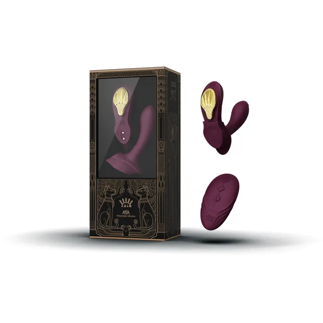 Zalo Legend Aya Velvet Purple dual-arm vibrator with remote beside the windowed black and gold retail box