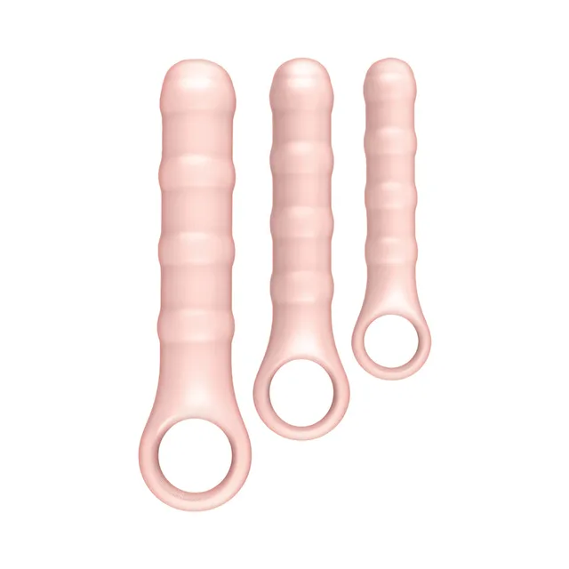 Three graduated beige Ass-Sation ribbed wands standing upright