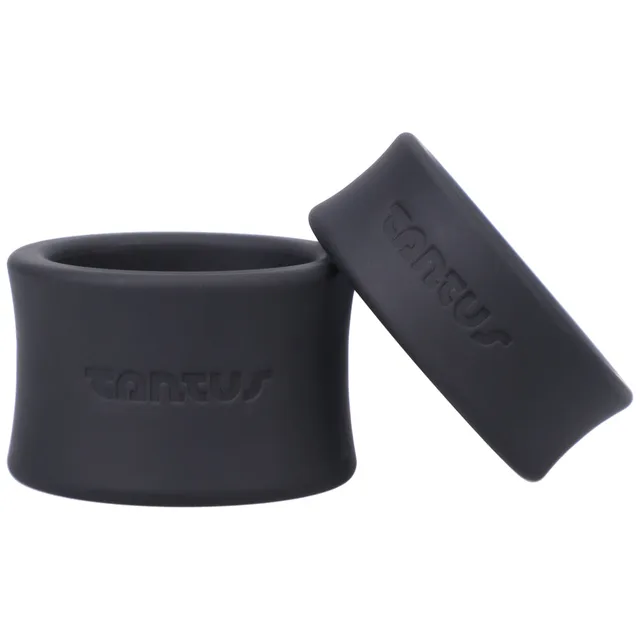 Two black Tantus ball stretcher bands posed upright and angled