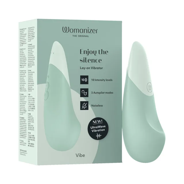 sage Womanizer Vibe vibrator standing beside pale green retail box