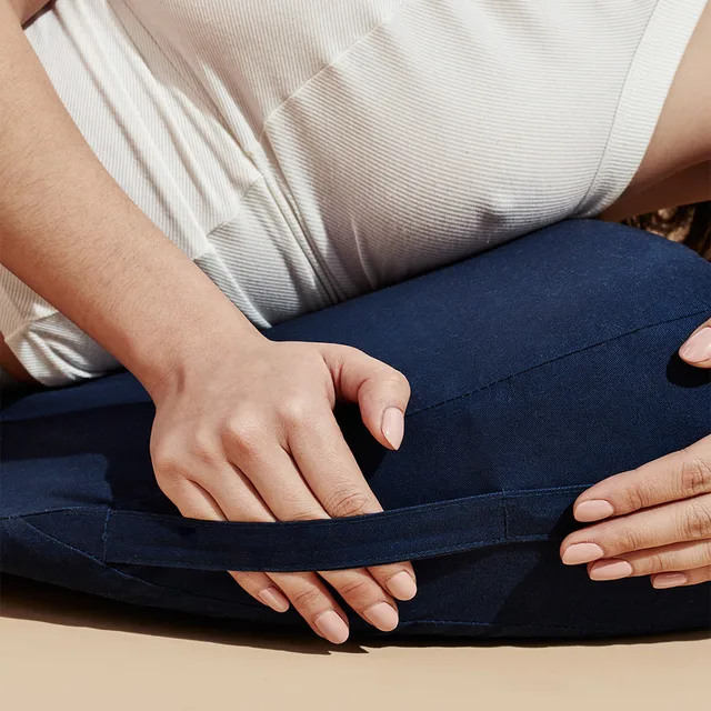 Dame Pillo indigo pillow beneath seated person