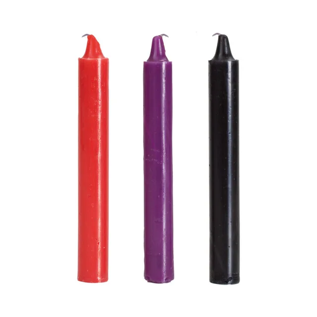 Three straight wax candles in red purple and black