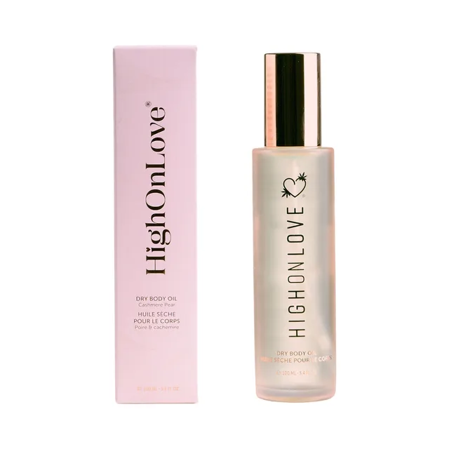HighOnLove Cashmere Pear dry body oil 3.4 oz clear bottle with gold cap beside the matching pink box