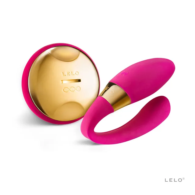 LELO TIANI 24K cerise couples massager with pink looped body beside oval gold-tone controller