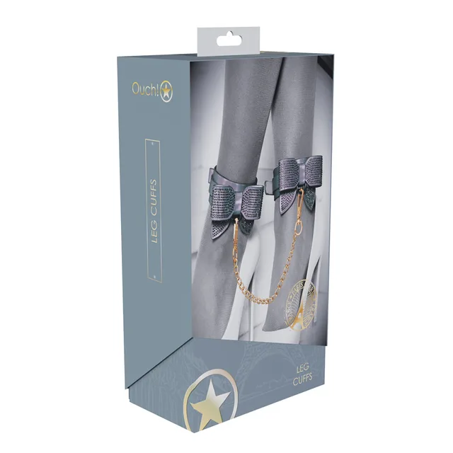 iridescent Paris leg cuffs with rhinestone bows and gold chain on box