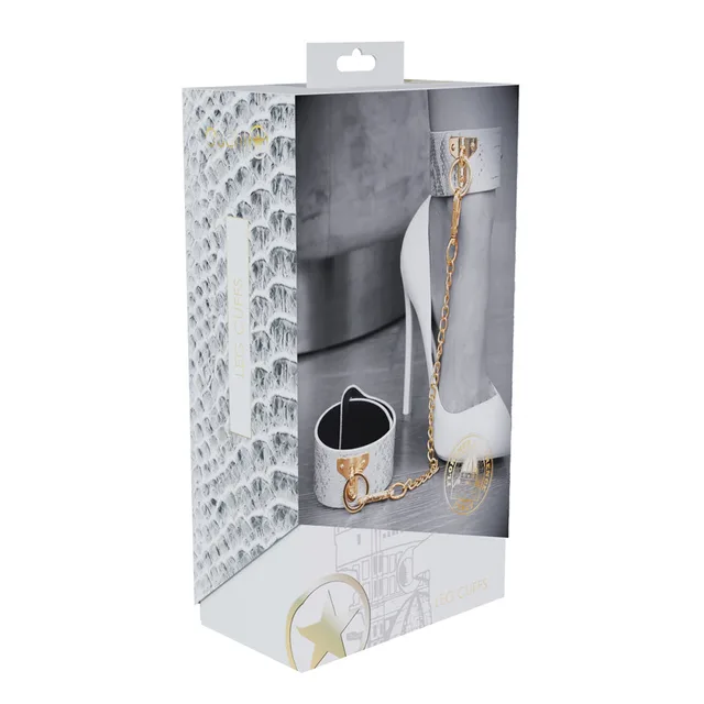 white and silver snakeskin Florence leg cuffs with gold chain on box