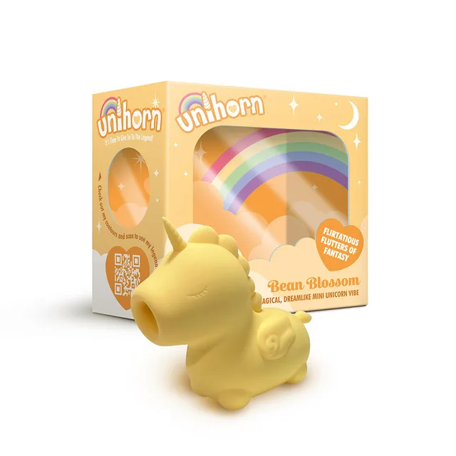 Creative Conceptions Unihorn Bean Blossom yellow unicorn vibrator beside rainbow retail box