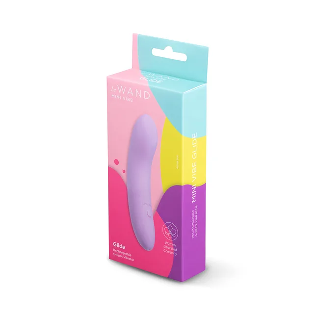 Light purple Le Wand Glide beside pink-and-teal retail box