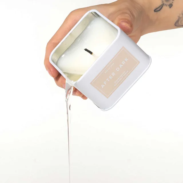 white Eye of Love After Dark square candle shown with melted wax pouring