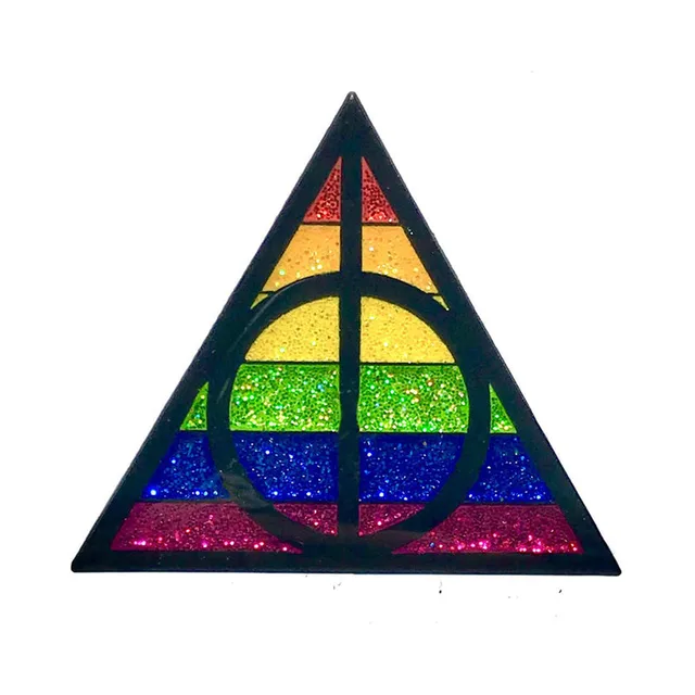 triangular Magic Pride enamel pin with rainbow glitter and black geometry