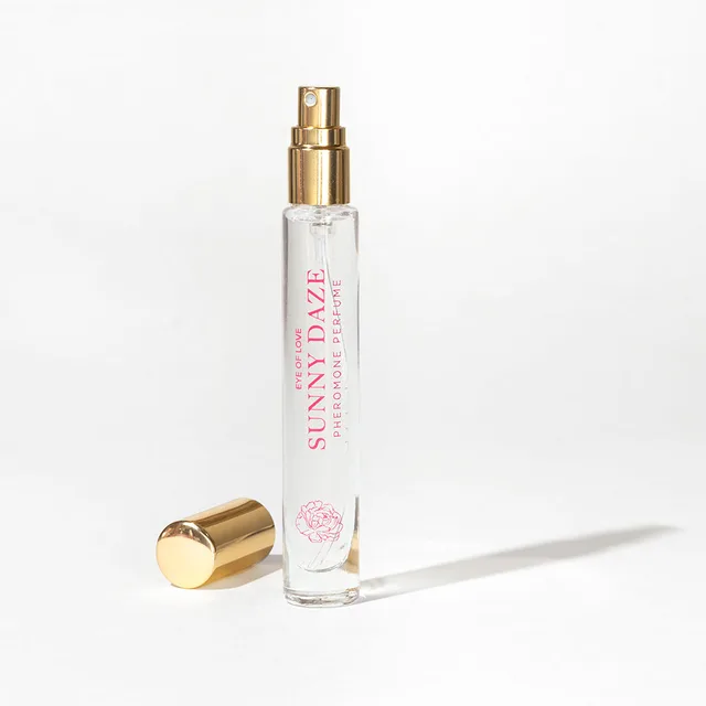 uncapped Sunny Daze slim spray vial with gold atomizer and cap on white