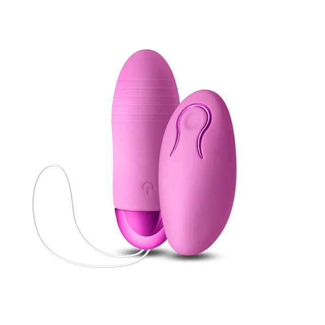 Pink Winx bullet beside oval wireless remote and retrieval cord