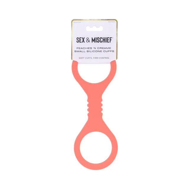 Small coral-orange figure-eight cuffs hanging from white header card