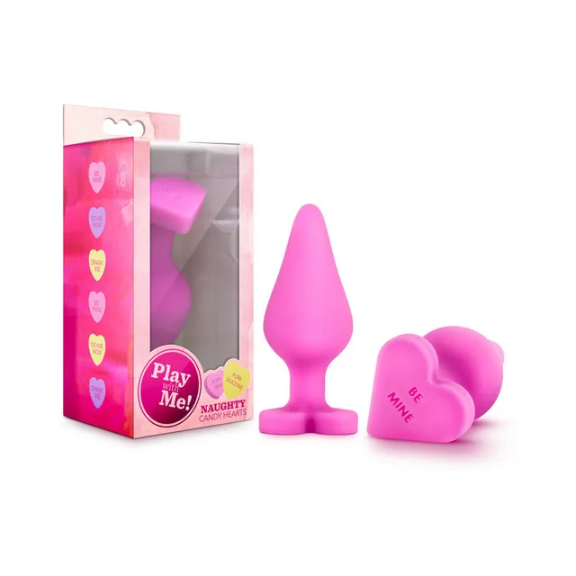 Naughty Candy Hearts Be Mine pink plug and heart base beside package