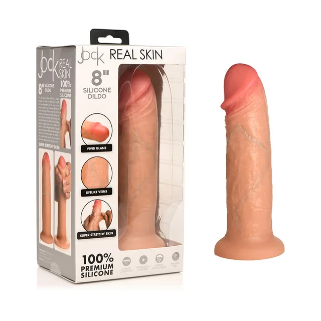 light-tone Jock Real Skin silicone dildo with round suction base beside windowed box
