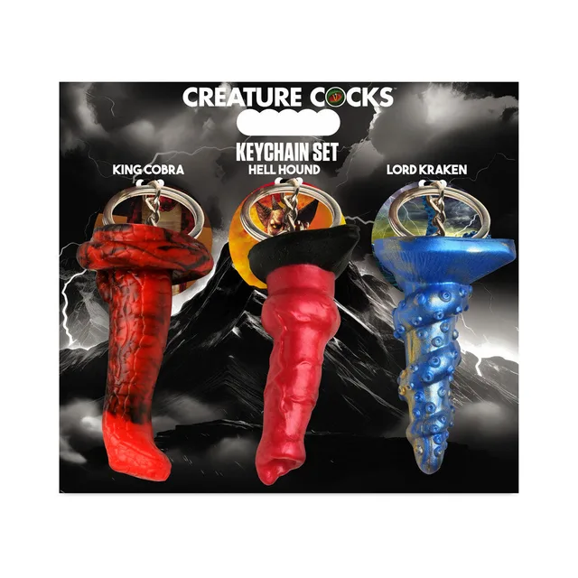 three Creature Cocks keychains in red orange and blue with metal rings