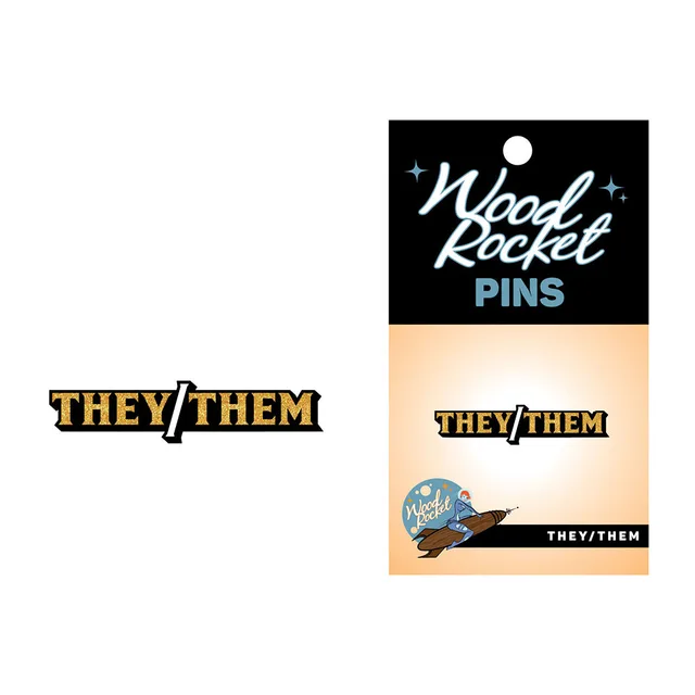 They Them gold glitter pin beside Wood Rocket backing card