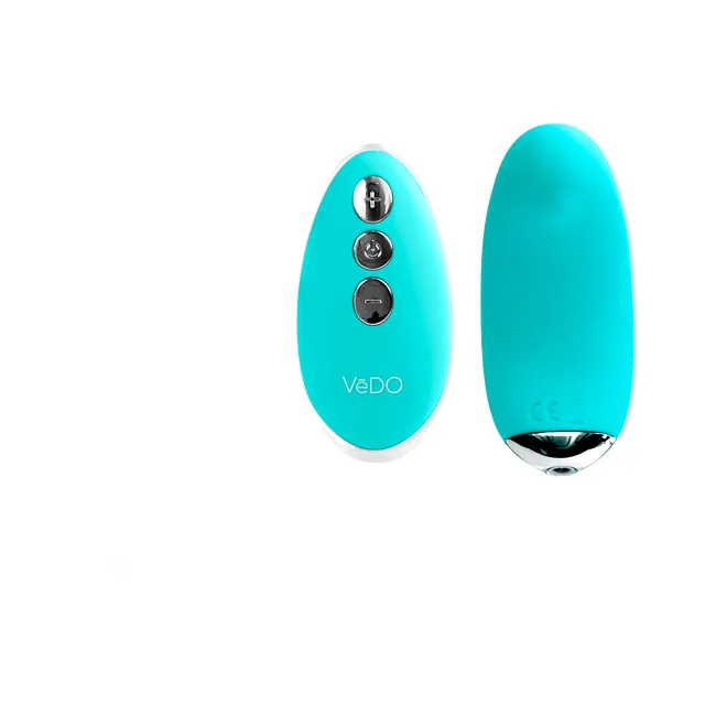 Turquoise Niki curved vibrator beside oval three-button remote