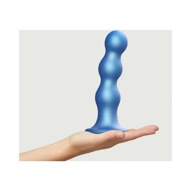 Extra-large blue triple-segment plug balanced on hand