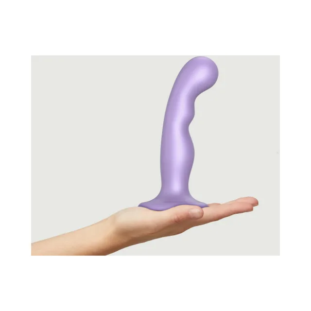 Medium lilac curved dildo plug balanced on hand