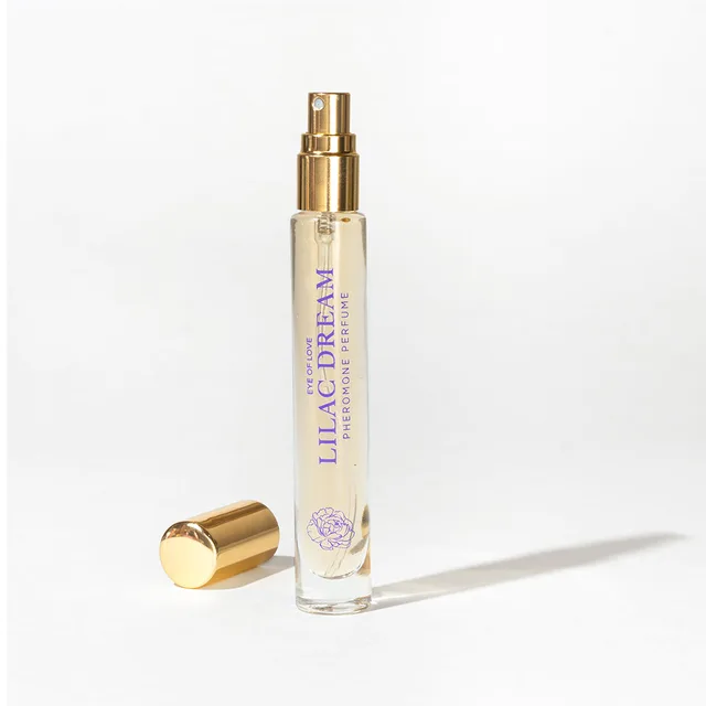 uncapped Lilac Dream slim spray vial with gold atomizer and cap on white