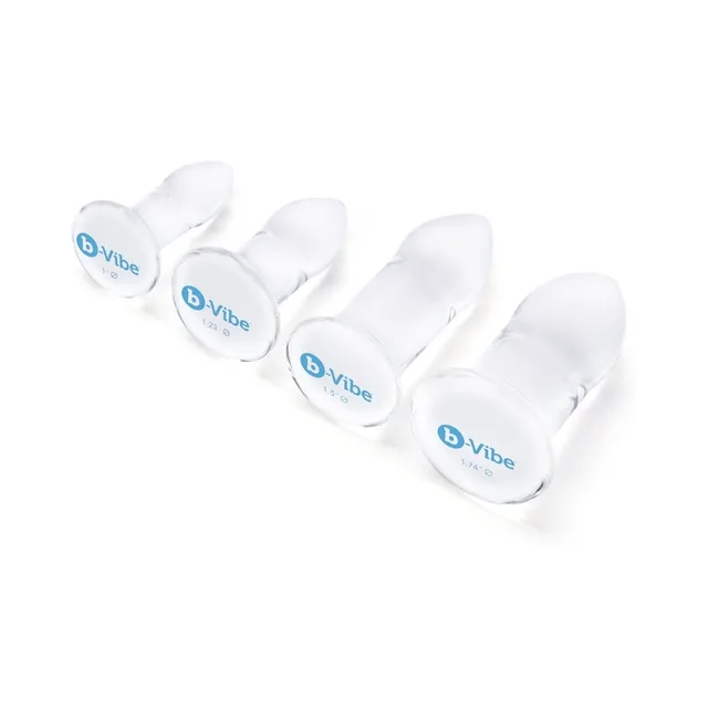 Four clear b-Vibe glass plugs arranged from small to large