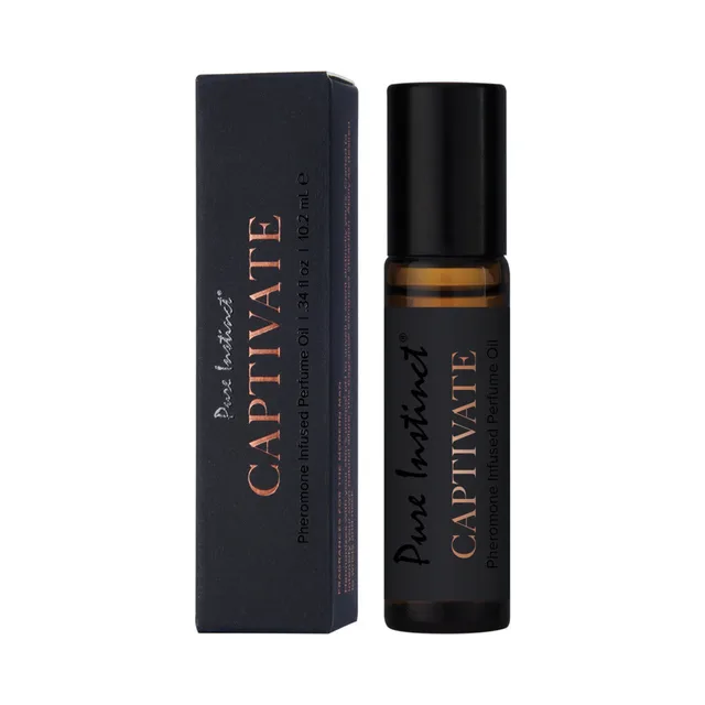 Pure Instinct Captivate amber perfume oil beside black box