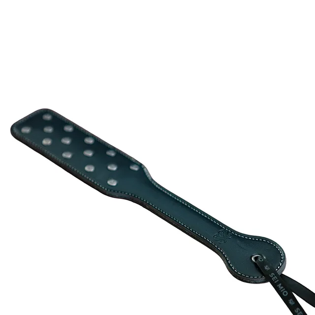 Black paddle with two rows of silver-tone studs and wrist loop