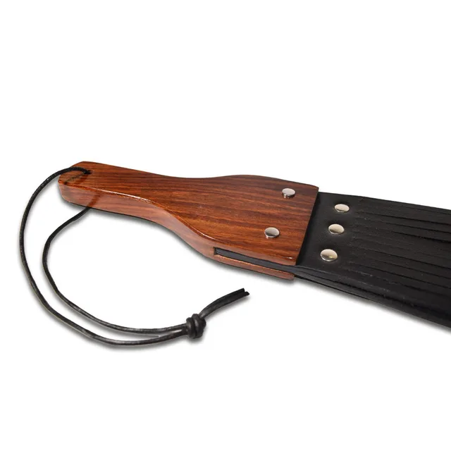 Close-up of Prowler RED wood handle and leather fringe fasteners