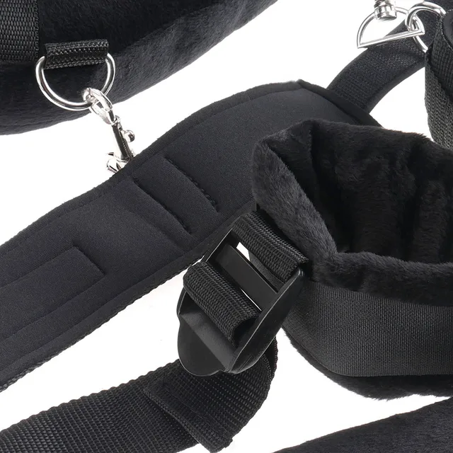 Close view of padded black cuff, ring, clip, and buckle hardware