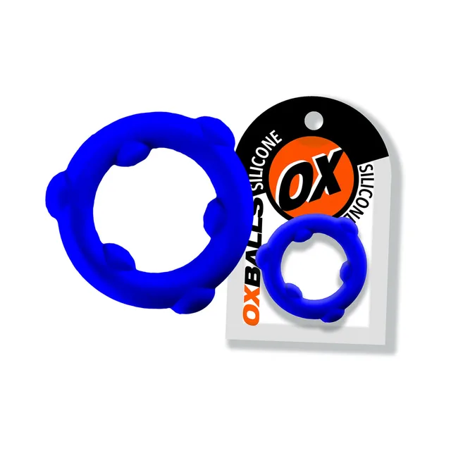 Glacier blue Oxballs Spinner ring with six raised nodes beside card