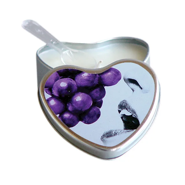 Open heart-shaped silver tin of Earthly Body grape massage candle with pouring corner