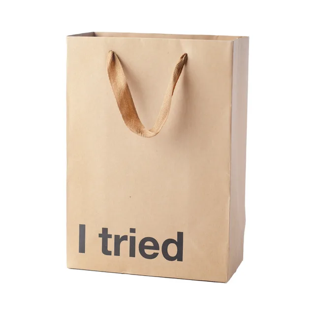 tan kraft gift bag with brown ribbon handles and I Tried text