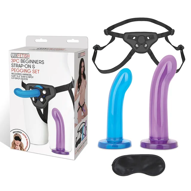 Boxed Lux Fetish kit beside blue and purple curved dildos