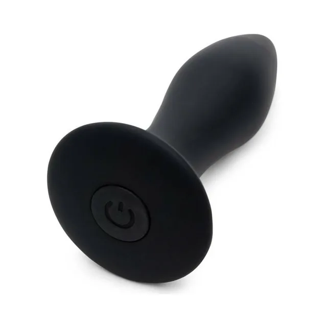 Close-up of round power button in flared butt plug base