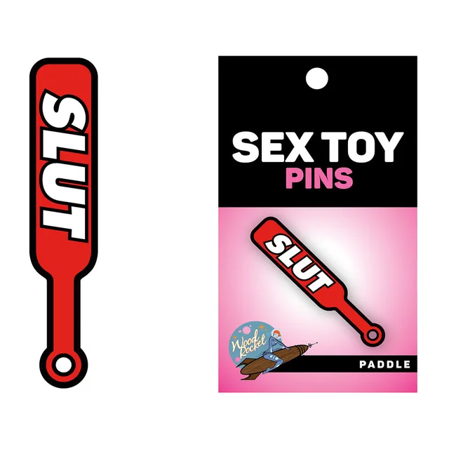 Wood Rocket red Paddle Slut enamel pin beside retail card