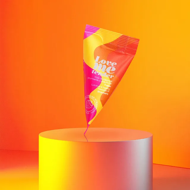 Love to Love Strawberry massage oil sachet angled packet among orange geometric shapes
